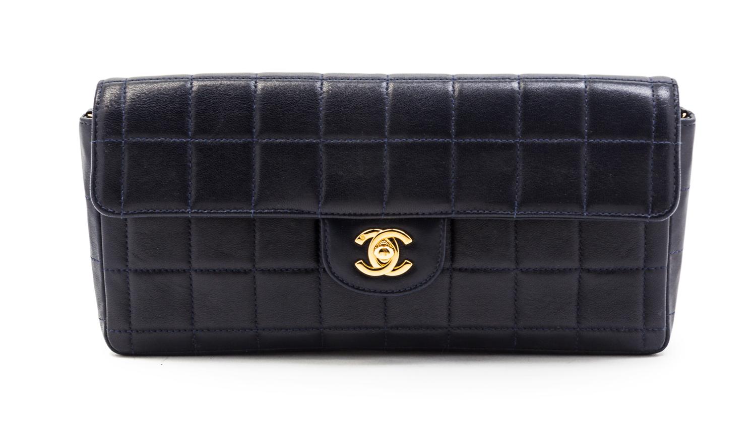 A Chanel Navy Quilted Leather Convertible Flap Bag, 10 1/2 x 5 x 1 1/2 inches.