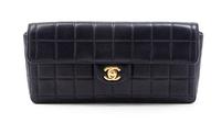 A Chanel Navy Quilted Leather Convertible Flap Bag, 10 1/2 x 5 x 1 1/2 inches.