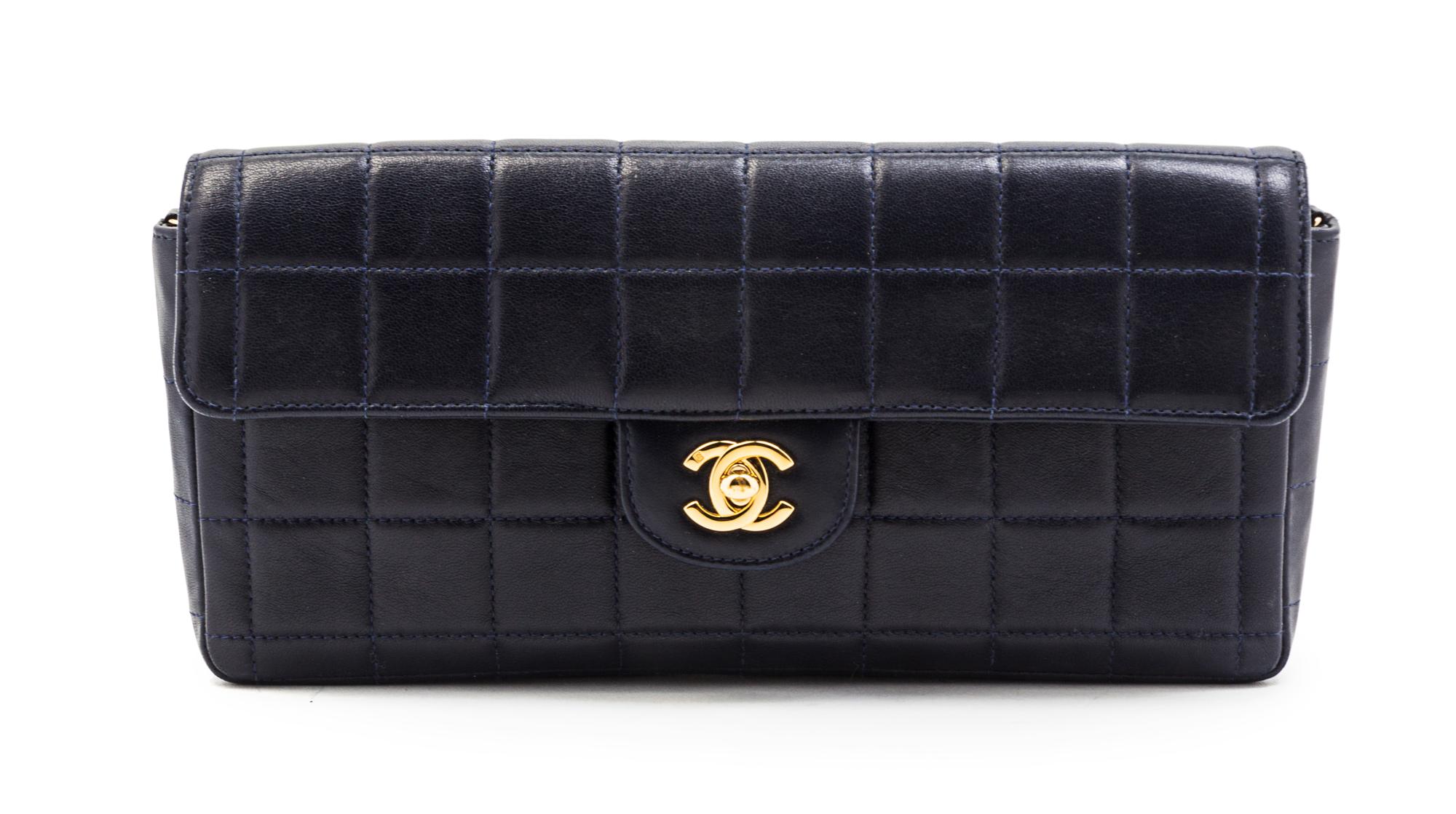 A Chanel Navy Quilted Leather Convertible Flap Bag, 10 1/2 x 5 x 1 1/2 inches.