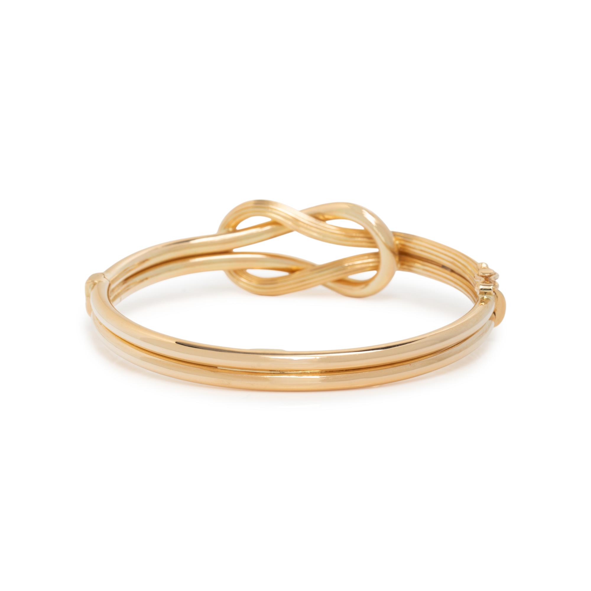 ILIAS LALAOUNIS, YELLOW GOLD BANGLE BRACELET