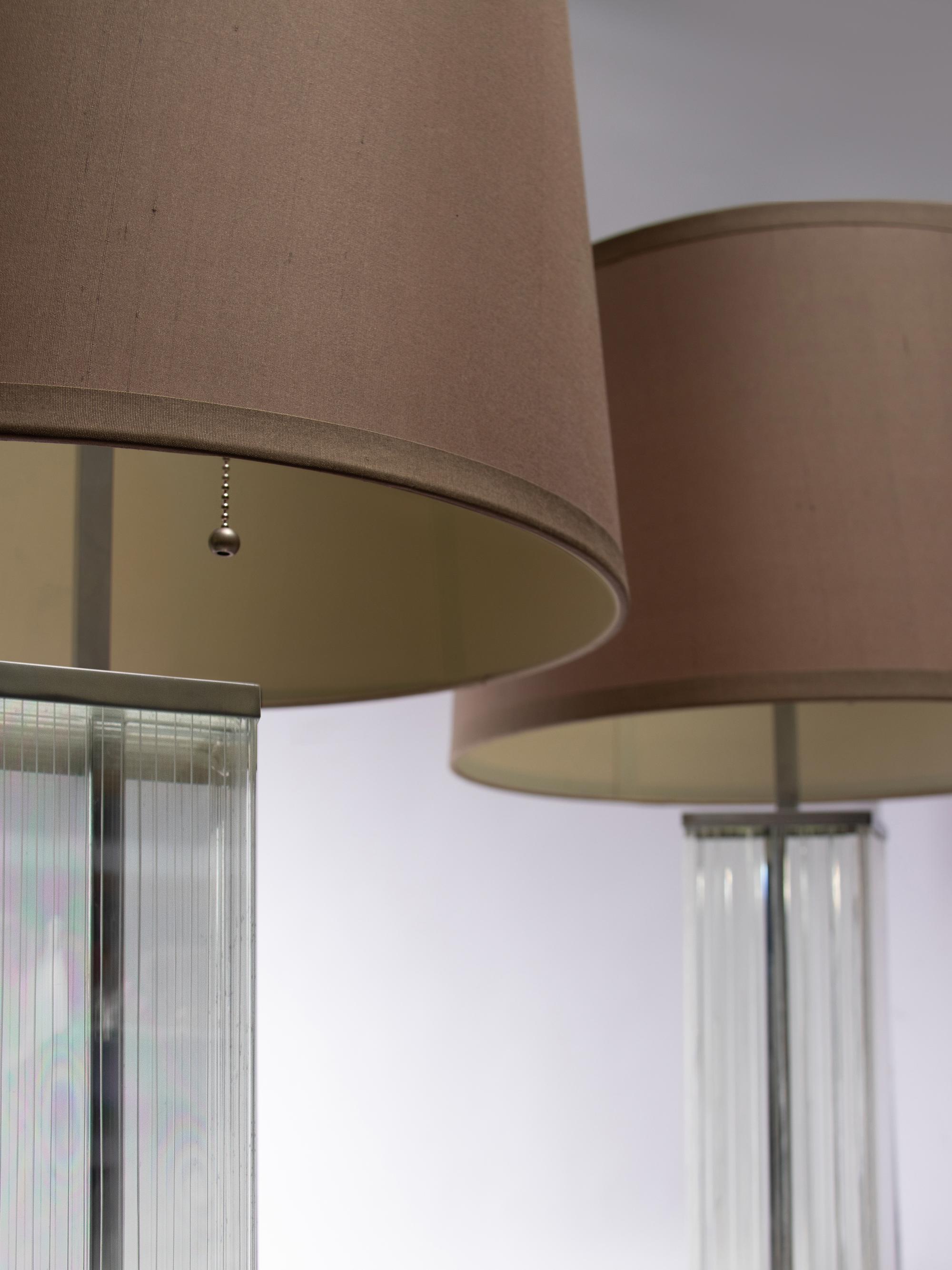 A Pair of Glass and Chromed Steel Table Lamps in the Style of Jean Michel Frank