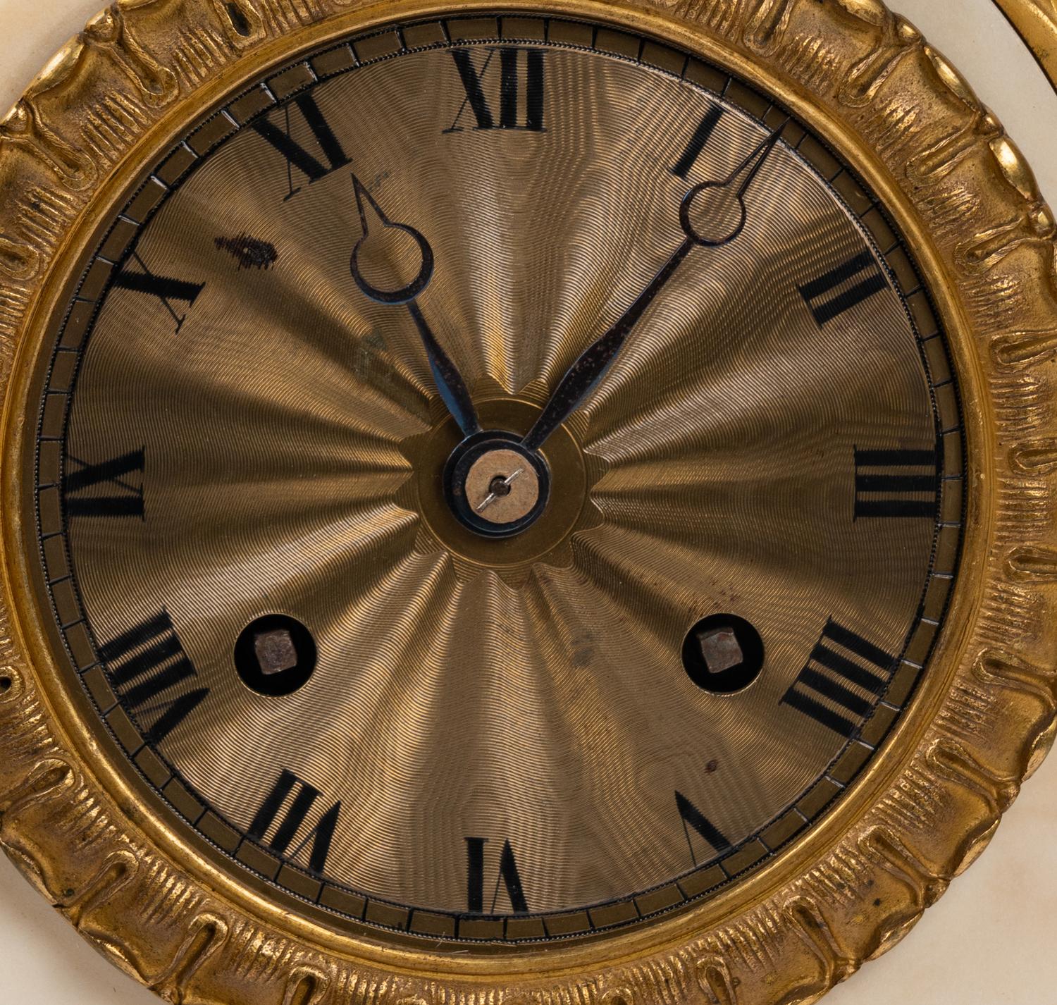 A Louis Philippe Gilt Bronze and White Marble Mantel Clock