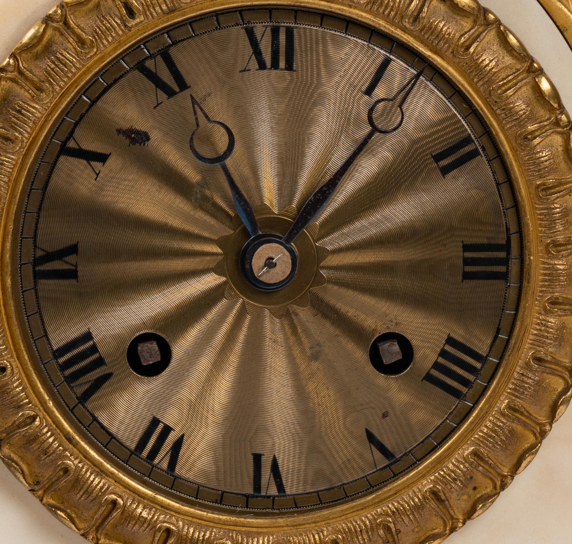 A Louis Philippe Gilt Bronze and White Marble Mantel Clock