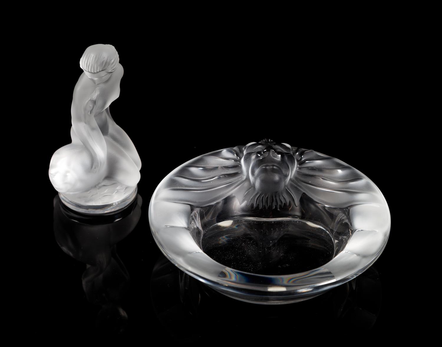 Lalique, a group of two molded and frosted glass articles, comprising a Tete de Lion ash receiver and a Leda and the Swan figure