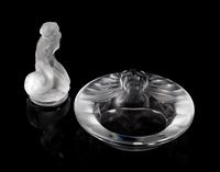Lalique, a group of two molded and frosted glass articles, comprising a Tete de Lion ash receiver and a Leda and the Swan figure