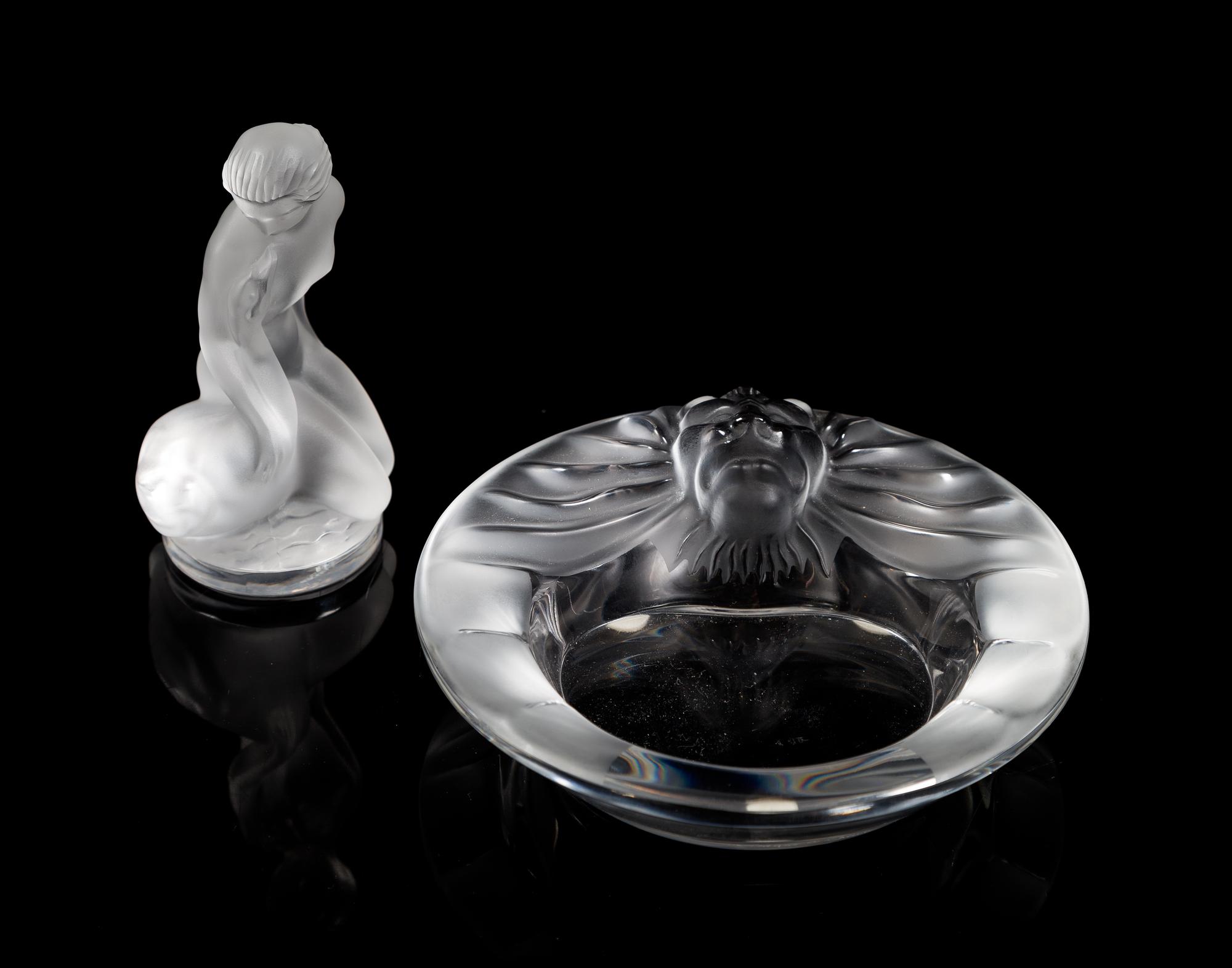 Lalique, a group of two molded and frosted glass articles, comprising a Tete de Lion ash receiver and a Leda and the Swan figure
