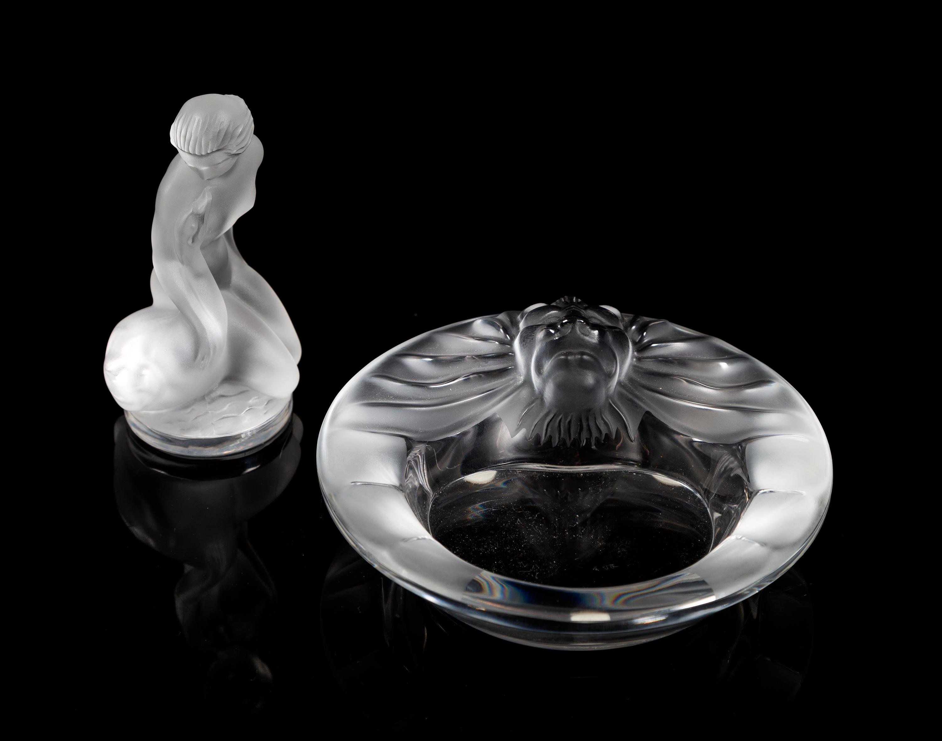 Lalique, a group of two molded and frosted glass articles, comprising a Tete de Lion ash receiver and a Leda and the Swan figure