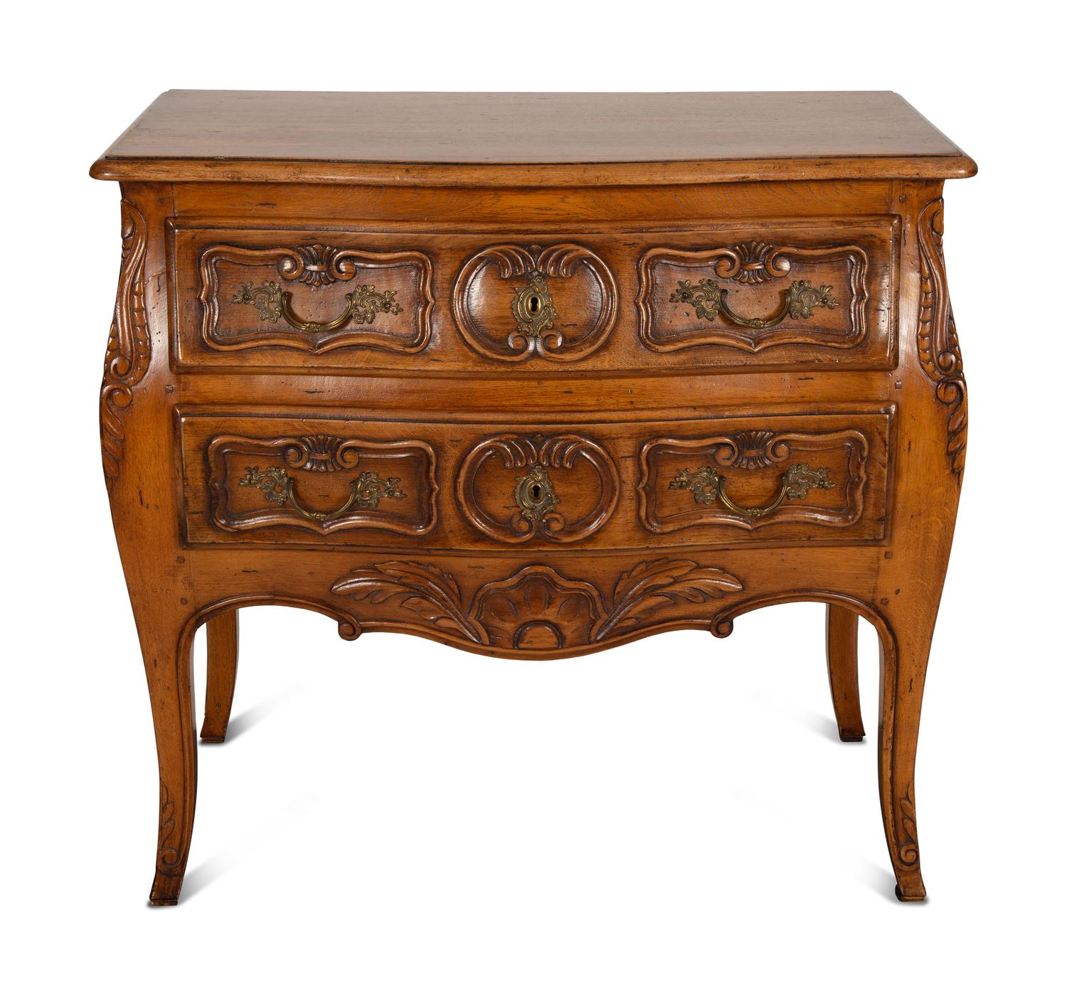 A Louis XV Provincial Style Carved Walnut Commode