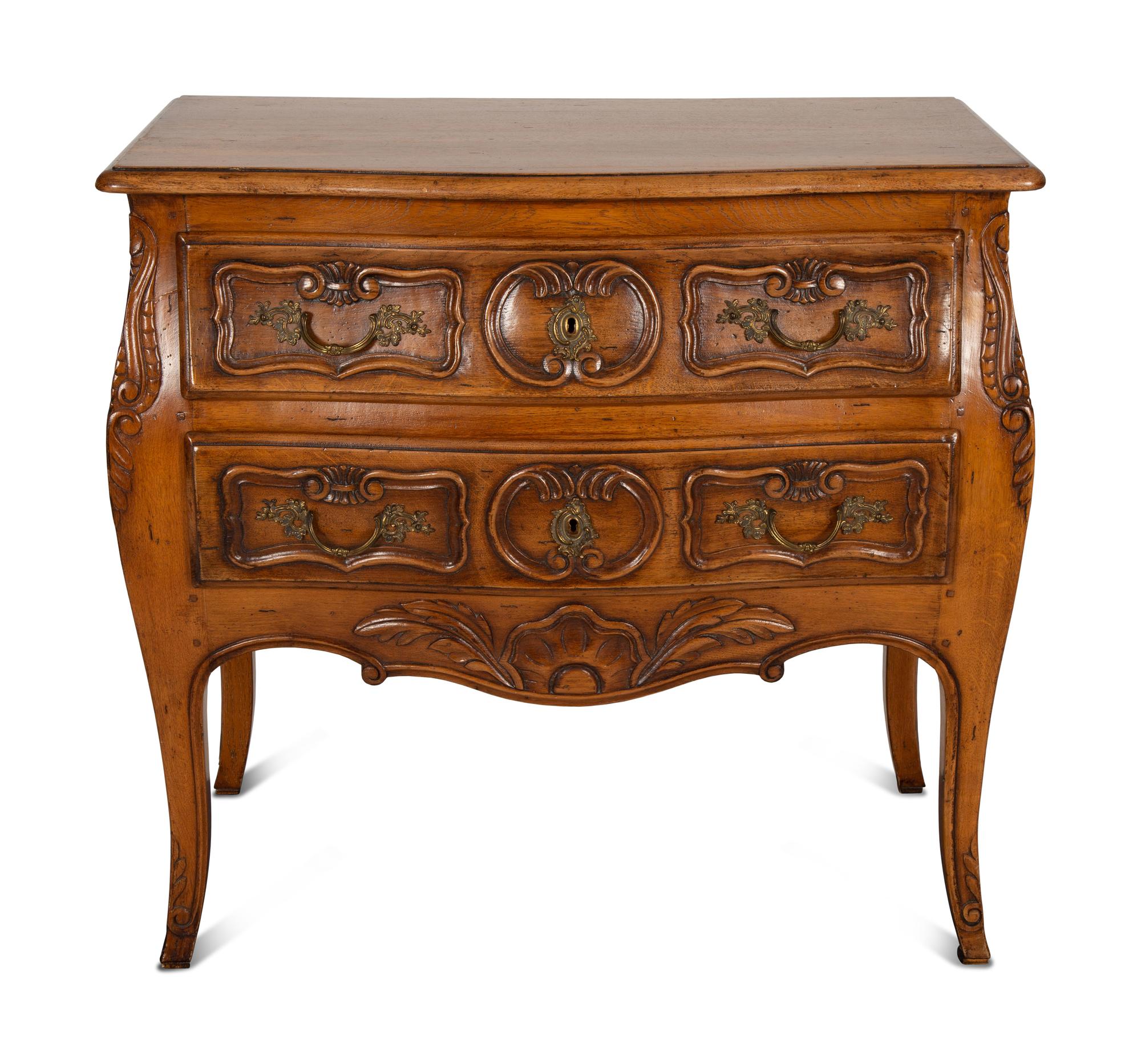 A Louis XV Provincial Style Carved Walnut Commode