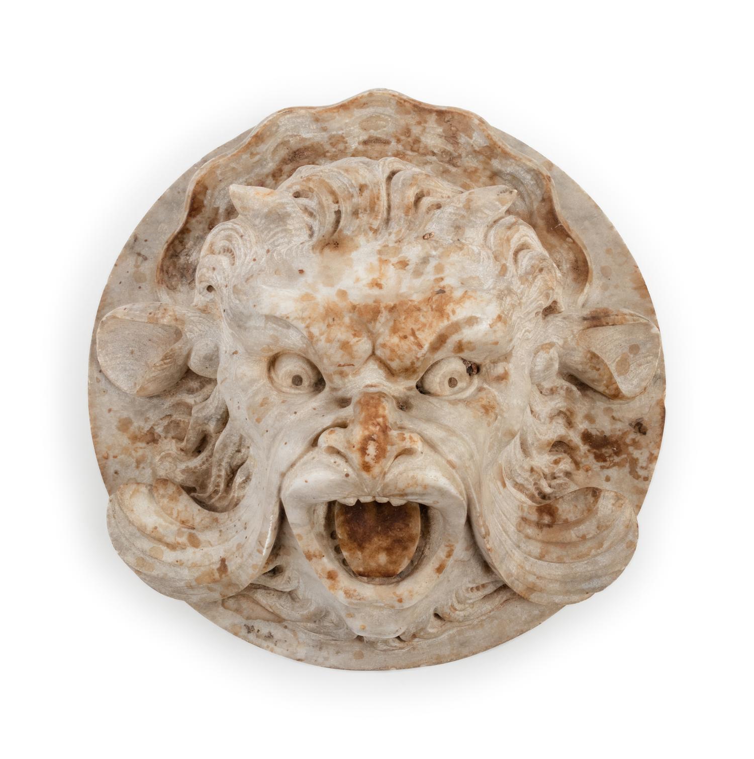 A Continental Carved Stone Grotesque Mask