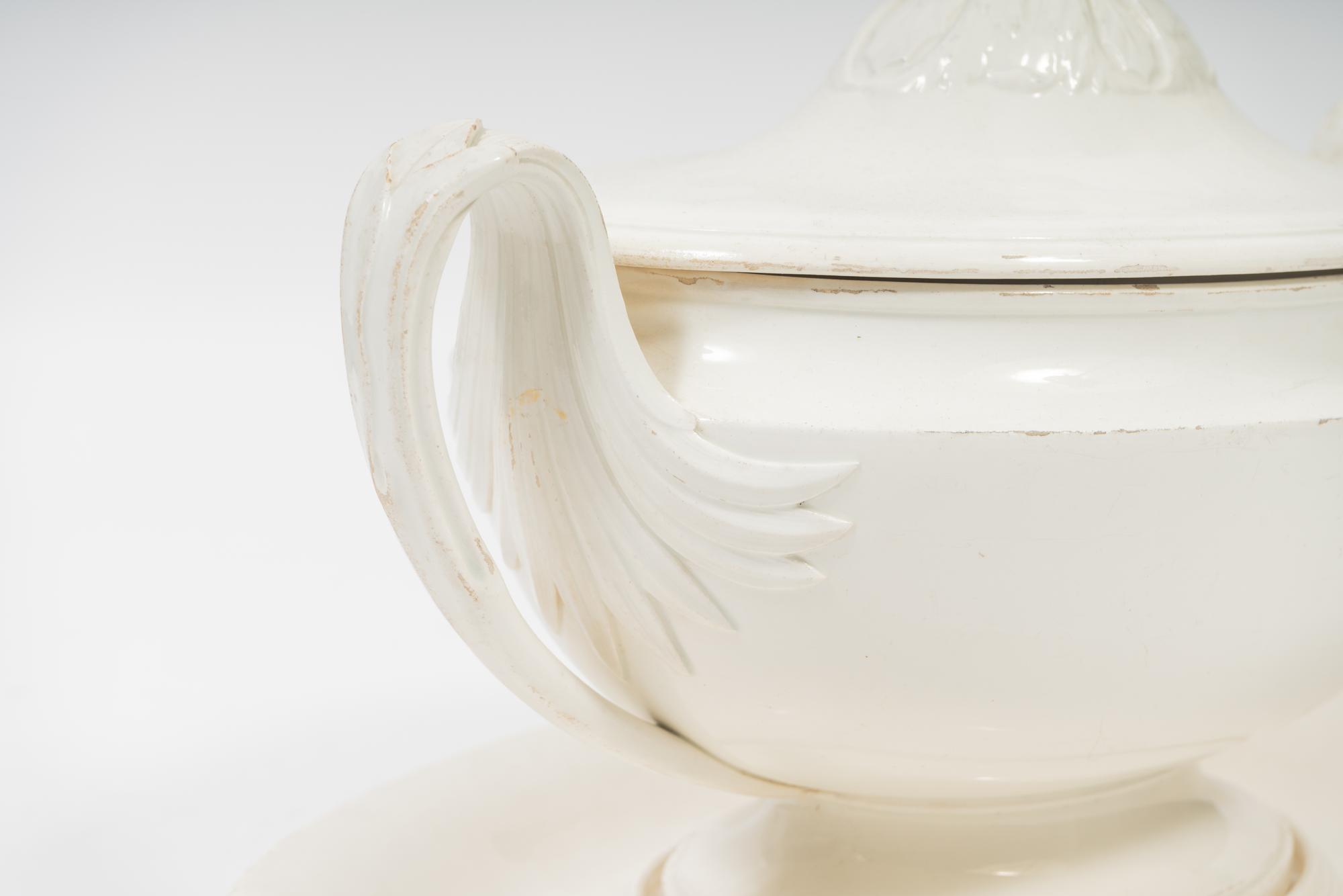 A French White Glazed Faïence Tureen and Underplate