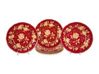 A Set of Twelve Wedgwood Porcelain Tonquin Rub y Dinner Plates