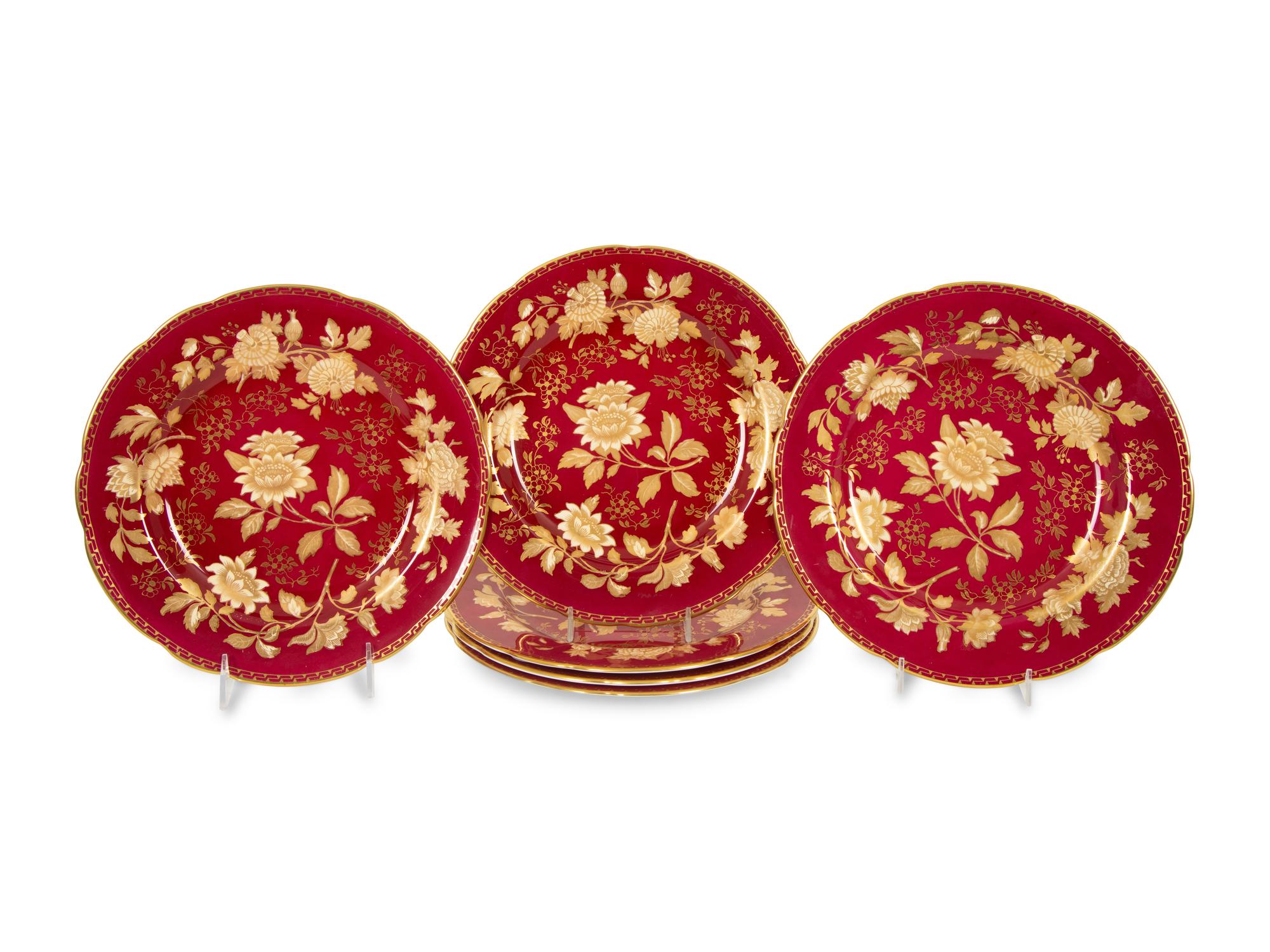 A Set of Twelve Wedgwood Porcelain Tonquin Rub y Dinner Plates