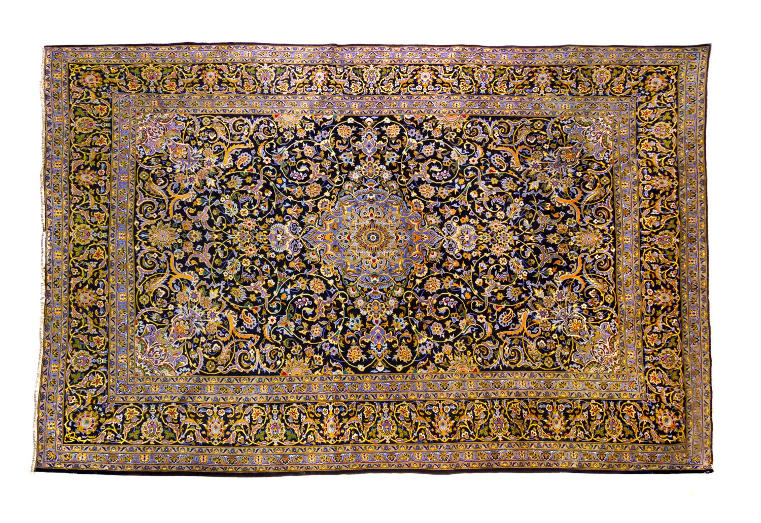 A Kashan Wool Rug 14 feet 1 inch x 9 feet 8 inches.