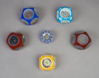 A Collection of Six Cased Glass Paperweights, Diameter of largest 3 1/2 inches.