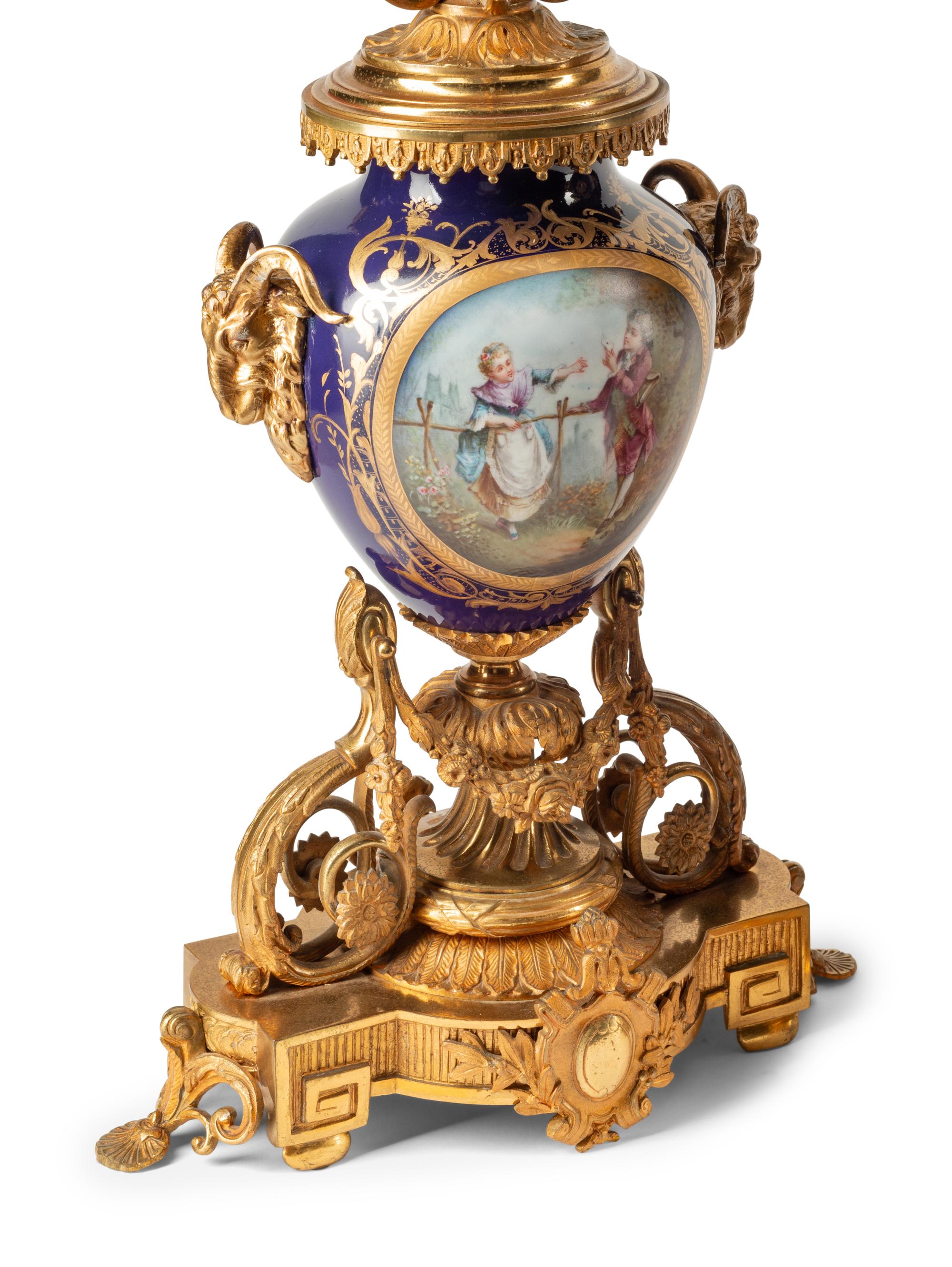 A French Gilt Bronze and Sèvres Style Porcelain Clock Garniture