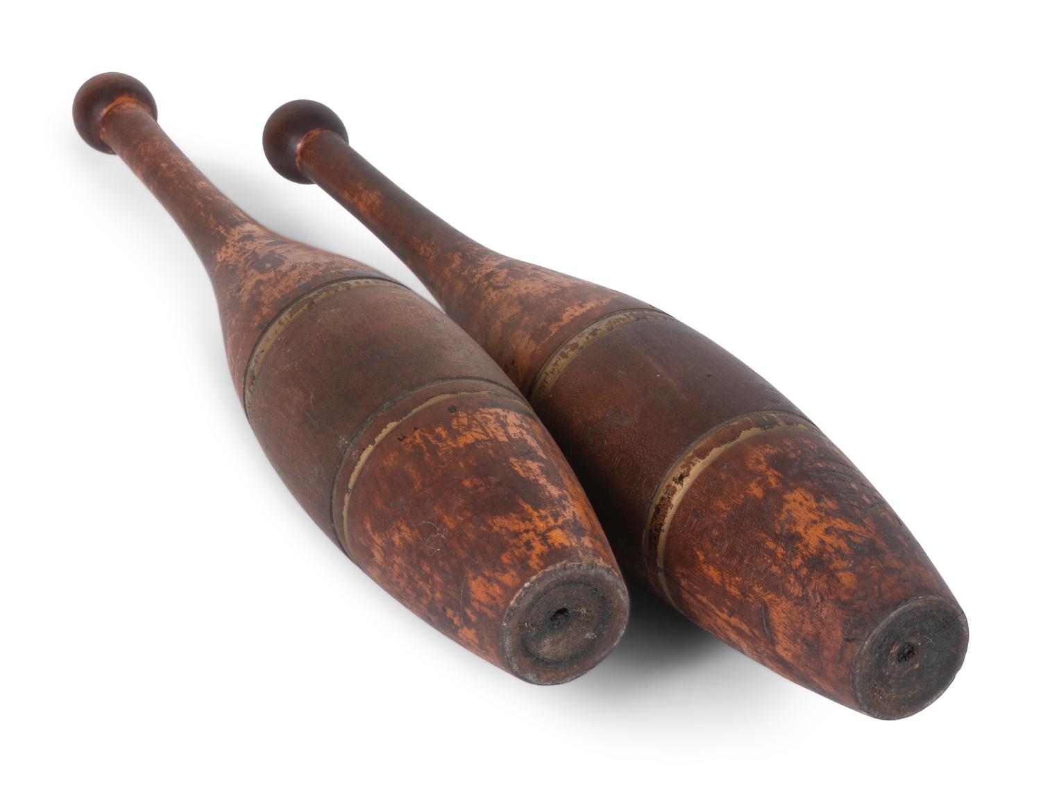 A Pair of Spalding 3Lb. Turned and Parcel Gilt Cherrywood Juggler's Pins