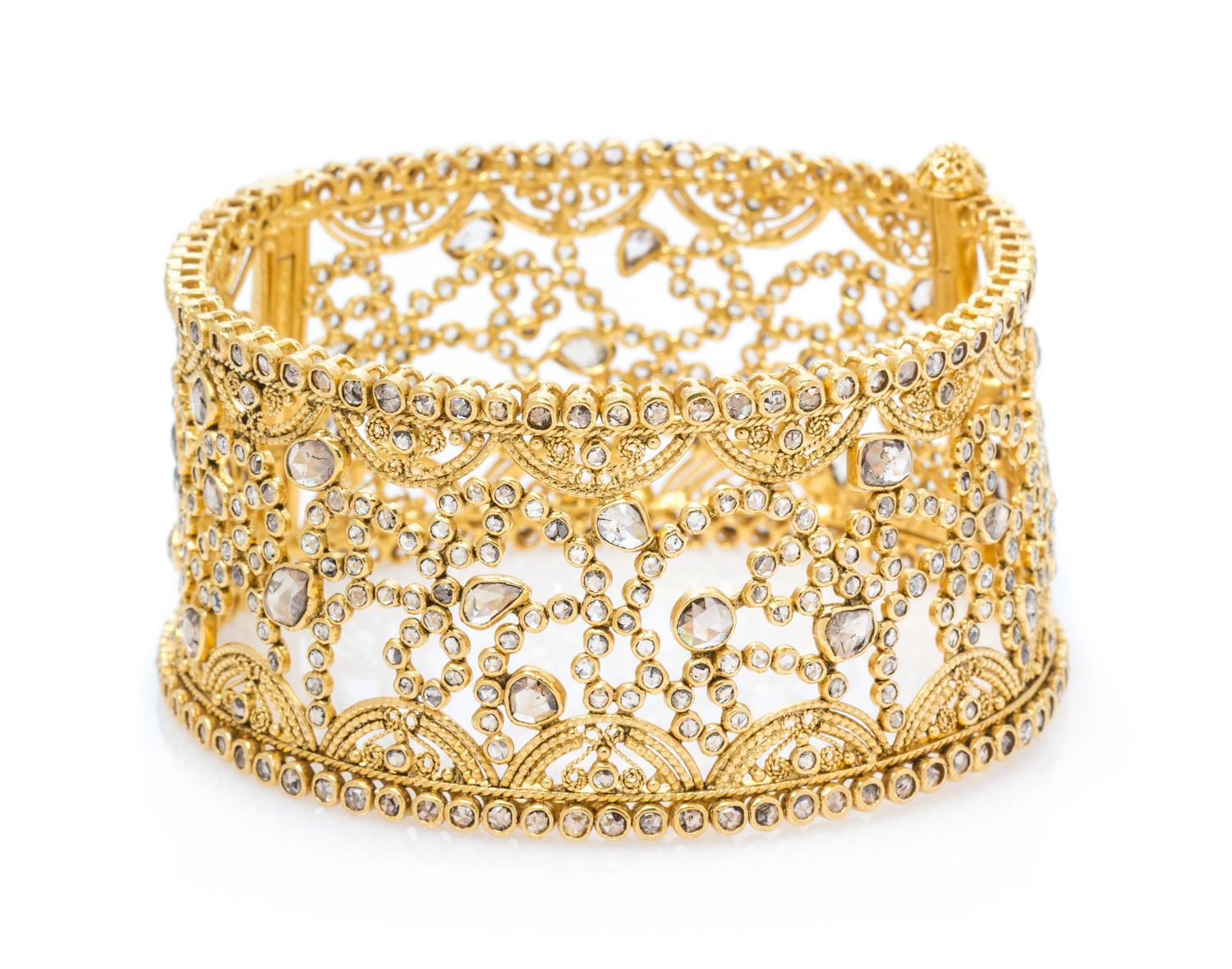 A High Karat Yellow Gold and Diamond Bangle Bracelet, 37.60 dwts.