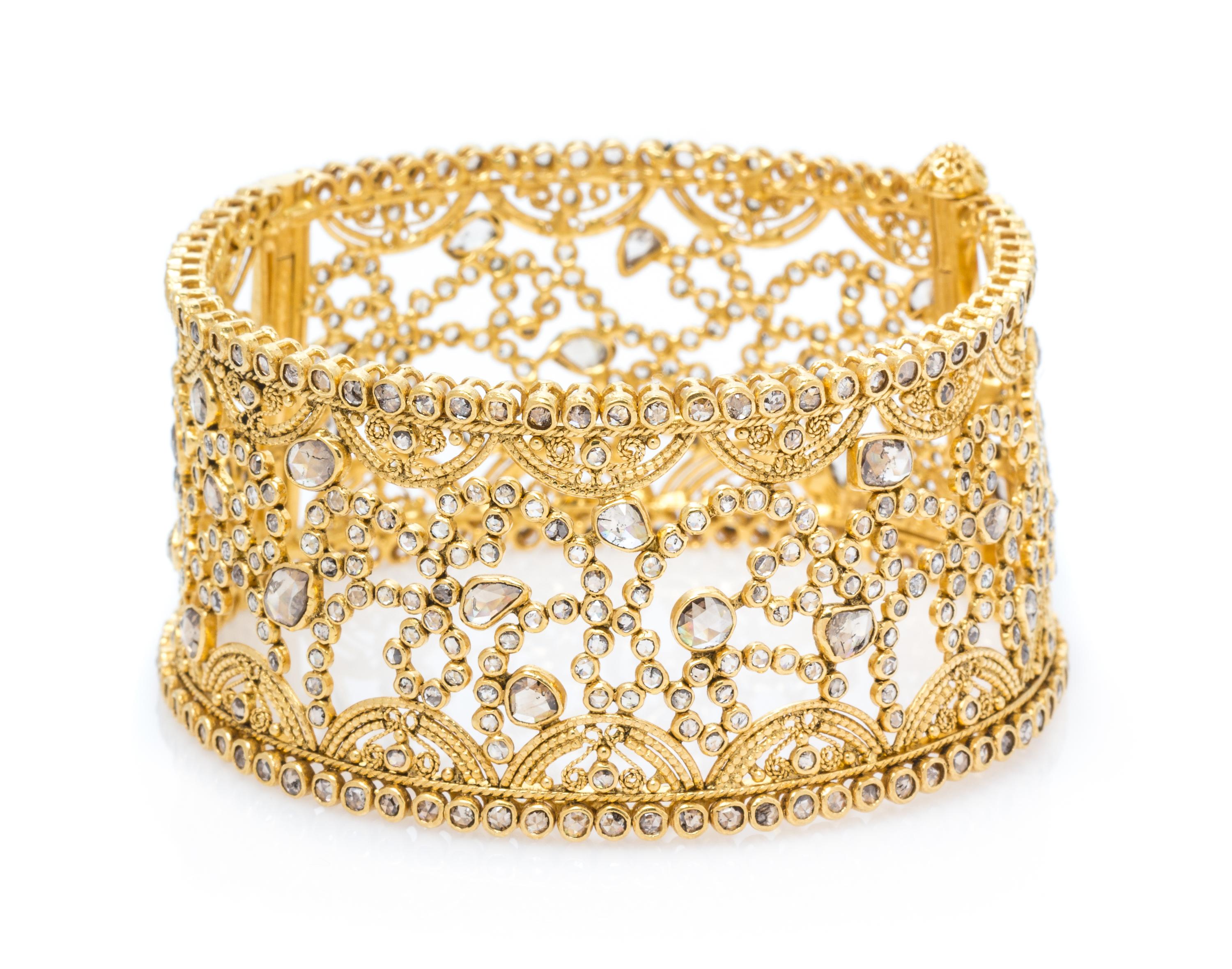 A High Karat Yellow Gold and Diamond Bangle Bracelet, 37.60 dwts.