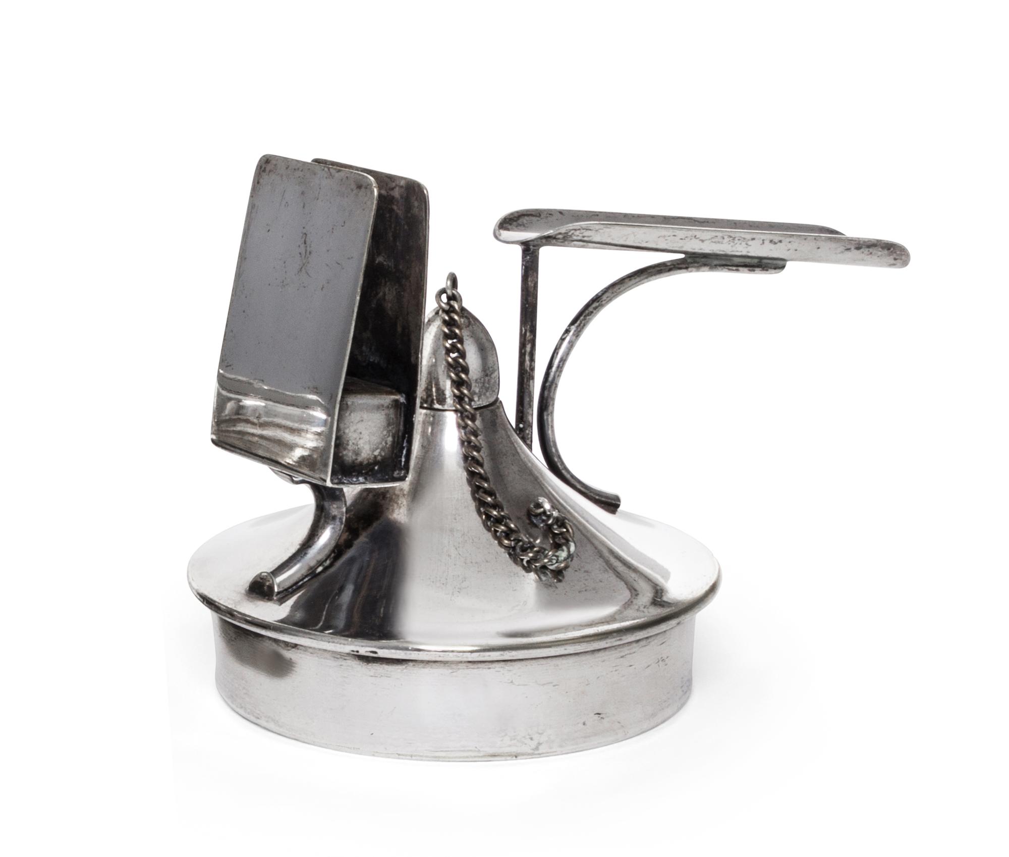 An Austrian Silver-Plate Cigar Lighter, 20th Century, of circular handled form with a matchbox holder.