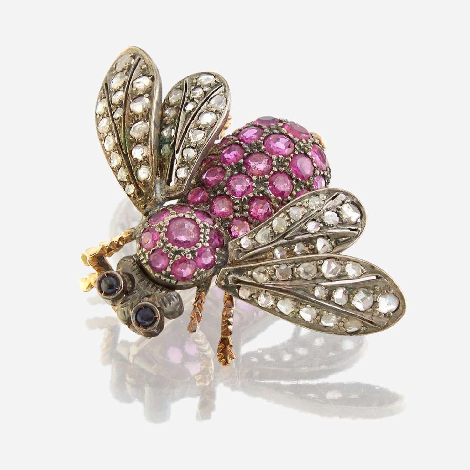 A silver topped gold, ruby, diamond, and sapphire brooch