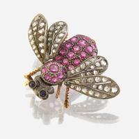 A silver topped gold, ruby, diamond, and sapphire brooch