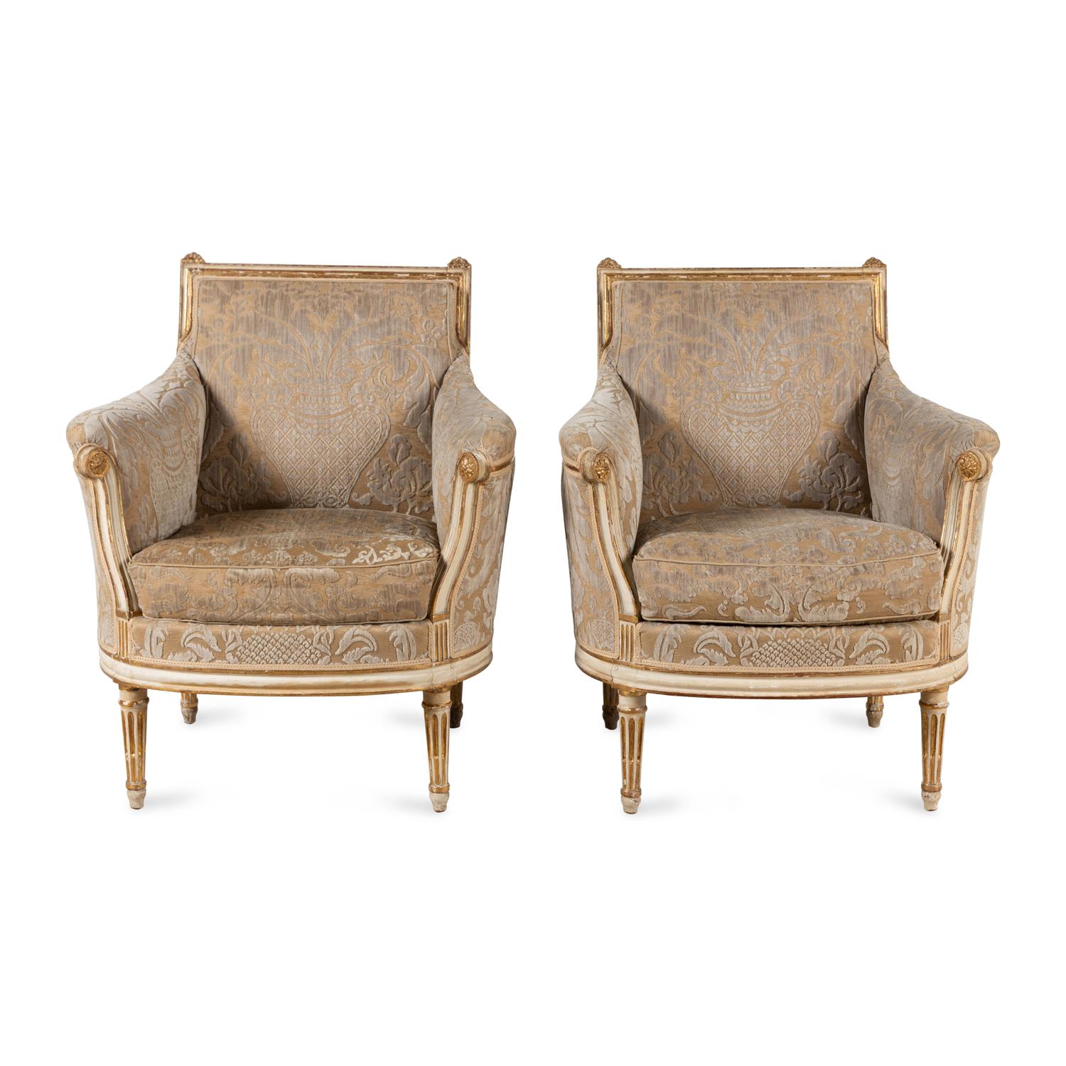 A Pair of Louis XVI Cream-Painted and Parcel Gilt Bergères