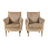 A Pair of Louis XVI Cream-Painted and Parcel Gilt Bergères