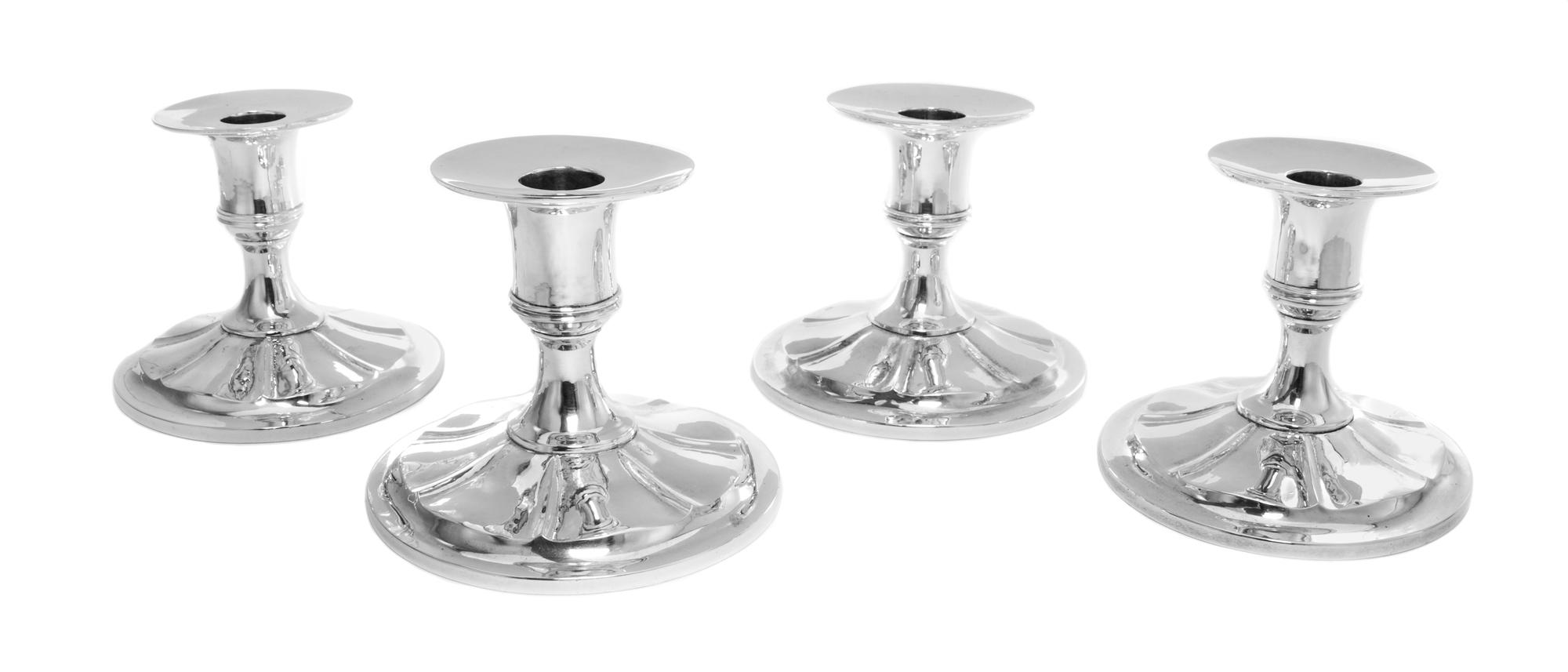 Four American Silver Candlesticks, Arthur Stone, Gardner, MA, 1906-1937, the candle cup above a stylized floriform base, weighted.