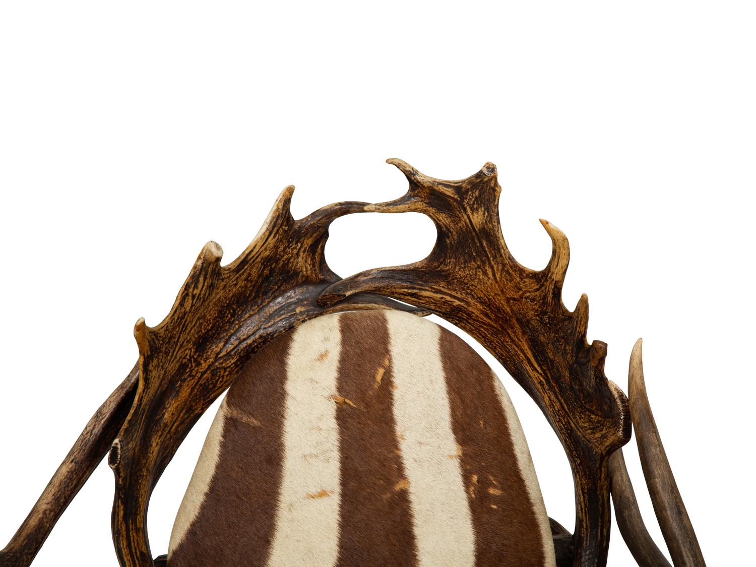 A Pair of Stag Antler Arm Chairs with Zebra Hide Upholstery Attributed to Anthony Redmile
