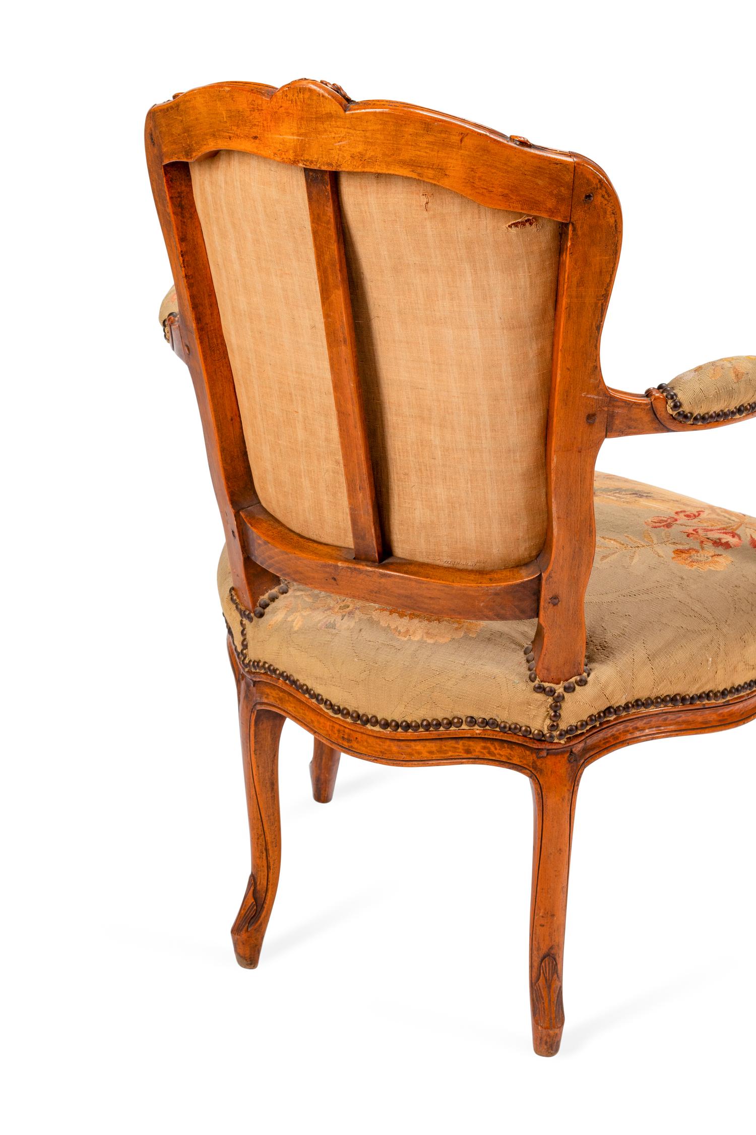A Pair of Louis XV Tapestry-Upholstered Walnut Fauteuils