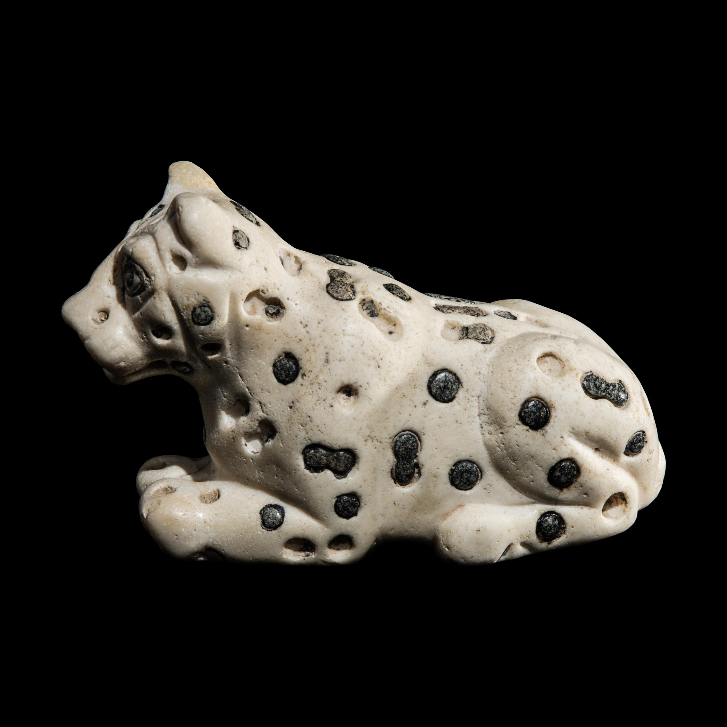 A Mesopotamian Marble and Lapis Lazuli Recumbent Leopard