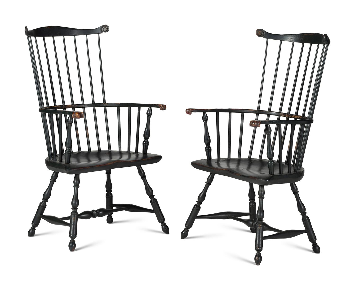 A Pair of Various Wood Black Painted Volute and Knuckle Carved Comb-Back Windsor Armchairs