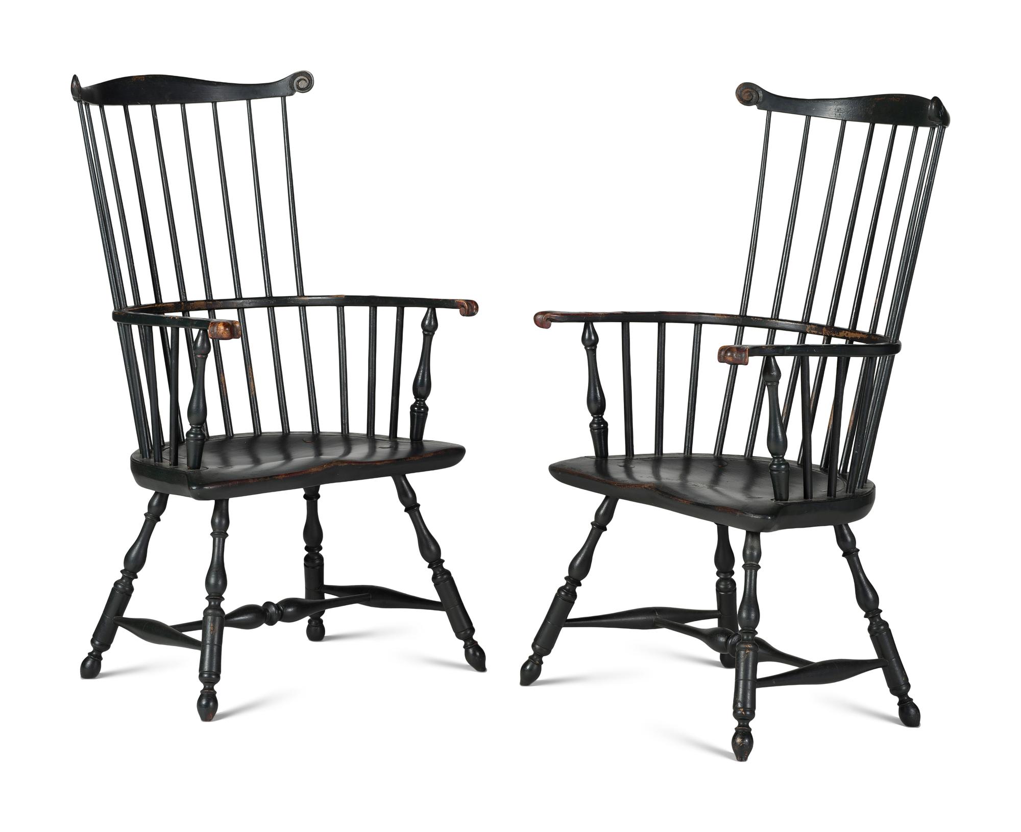 A Pair of Various Wood Black Painted Volute and Knuckle Carved Comb-Back Windsor Armchairs