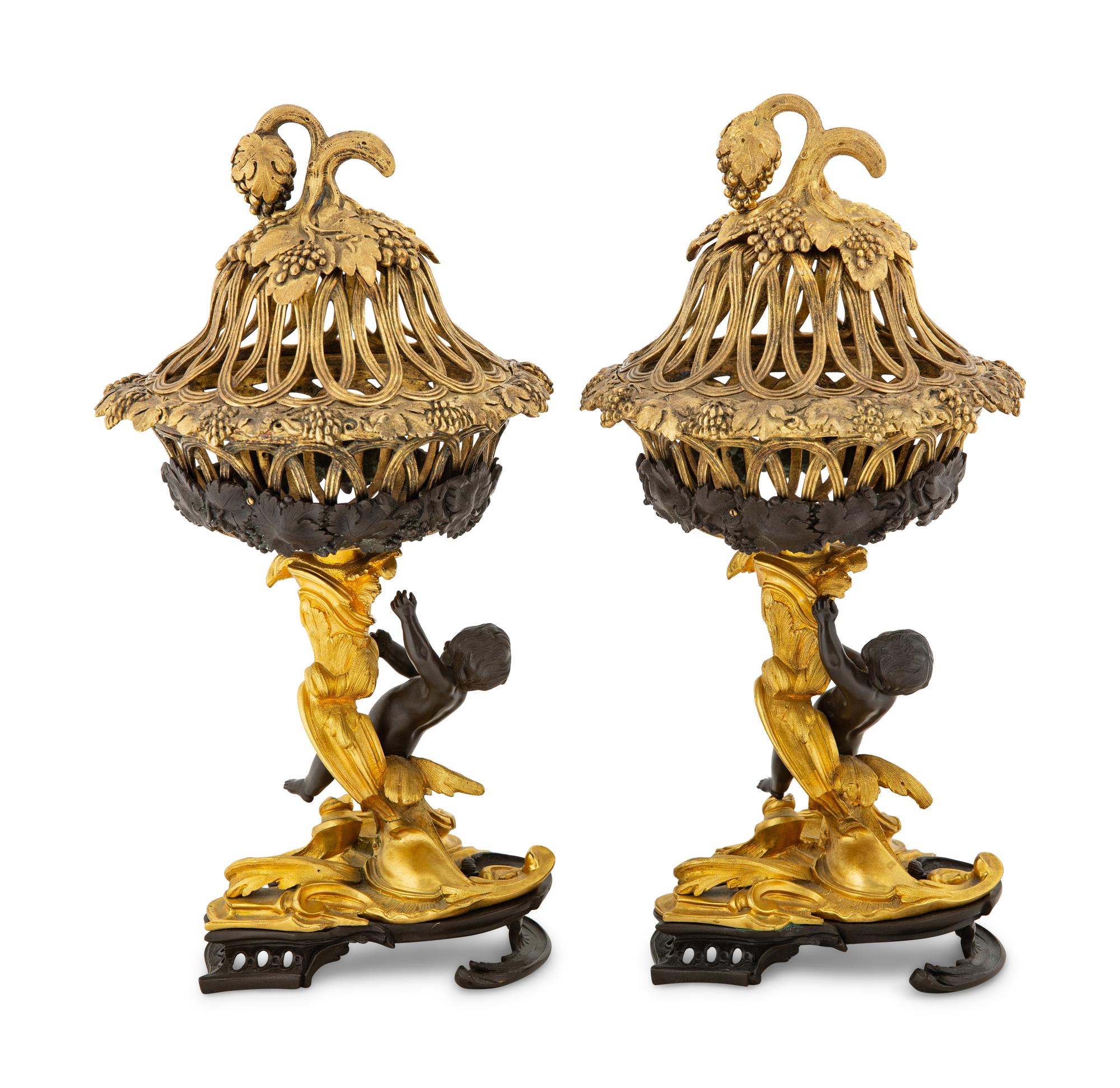 A Pair of Continental Rococo Style Parcel Gilt Bronze Figural Fruit Baskets