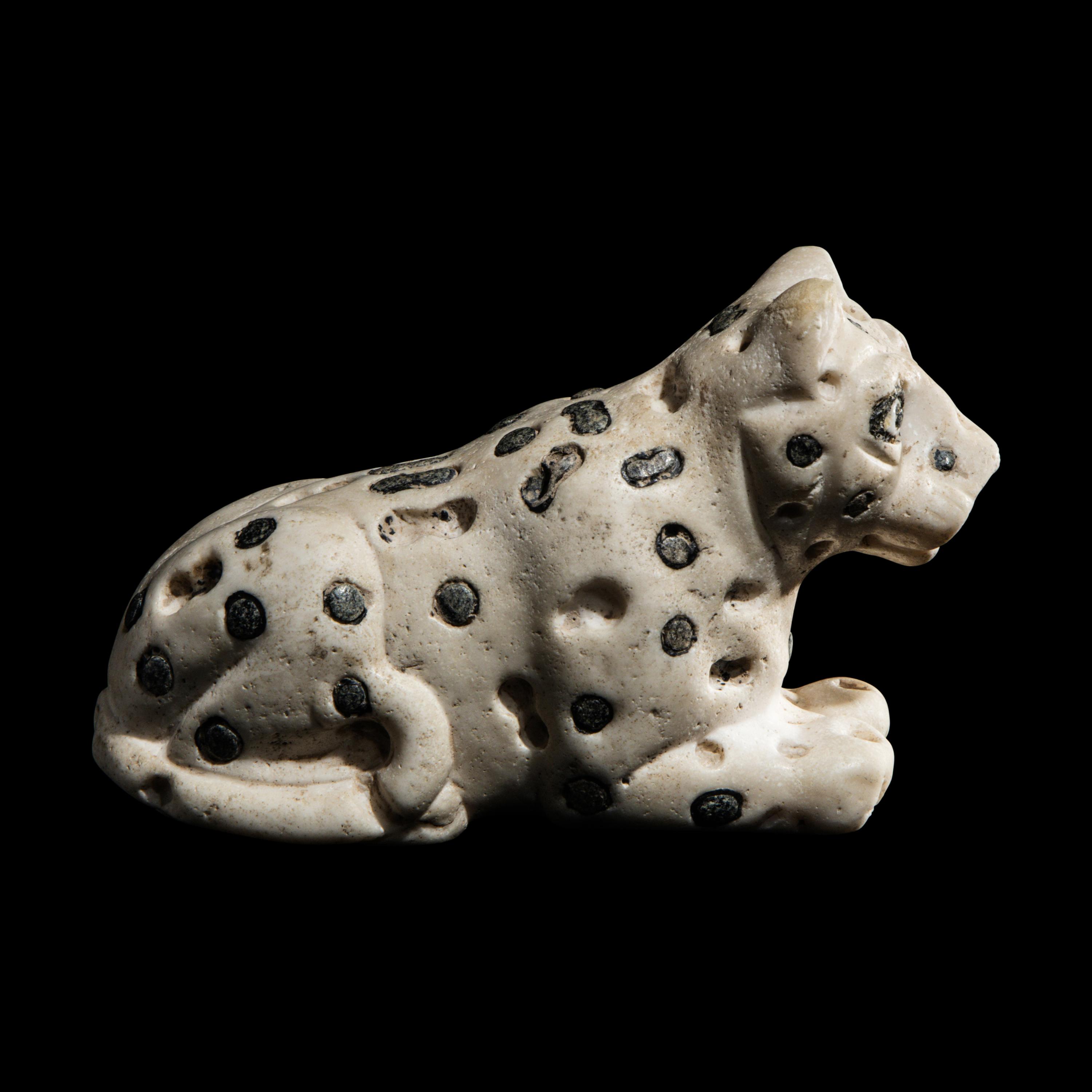 A Mesopotamian Marble and Lapis Lazuli Recumbent Leopard