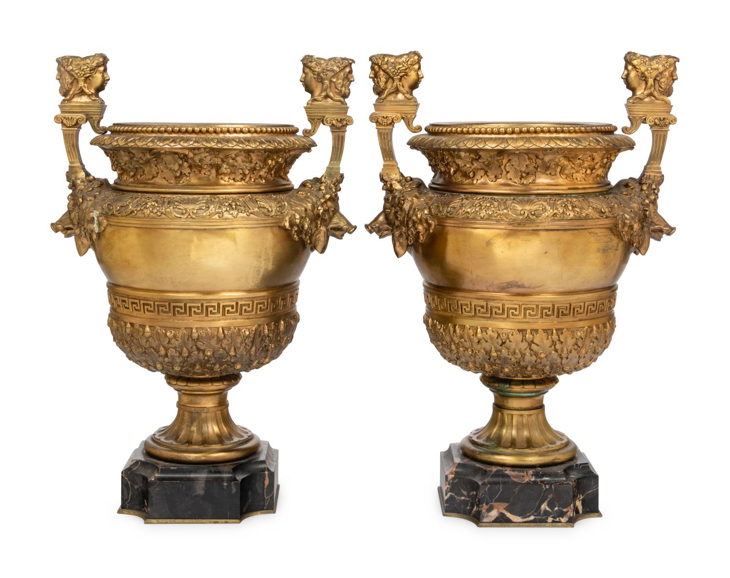 A Pair of Neoclassical Gilt Bronze Urns on Marble Plinths