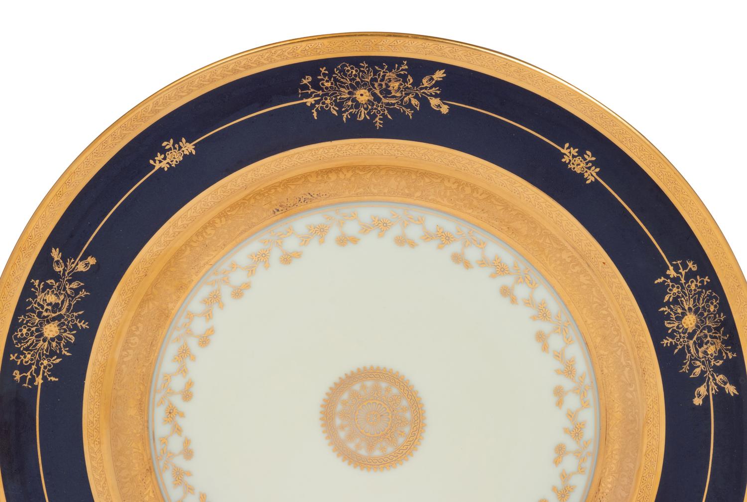 A Set of Twelve Limoges Porcelain Chargers