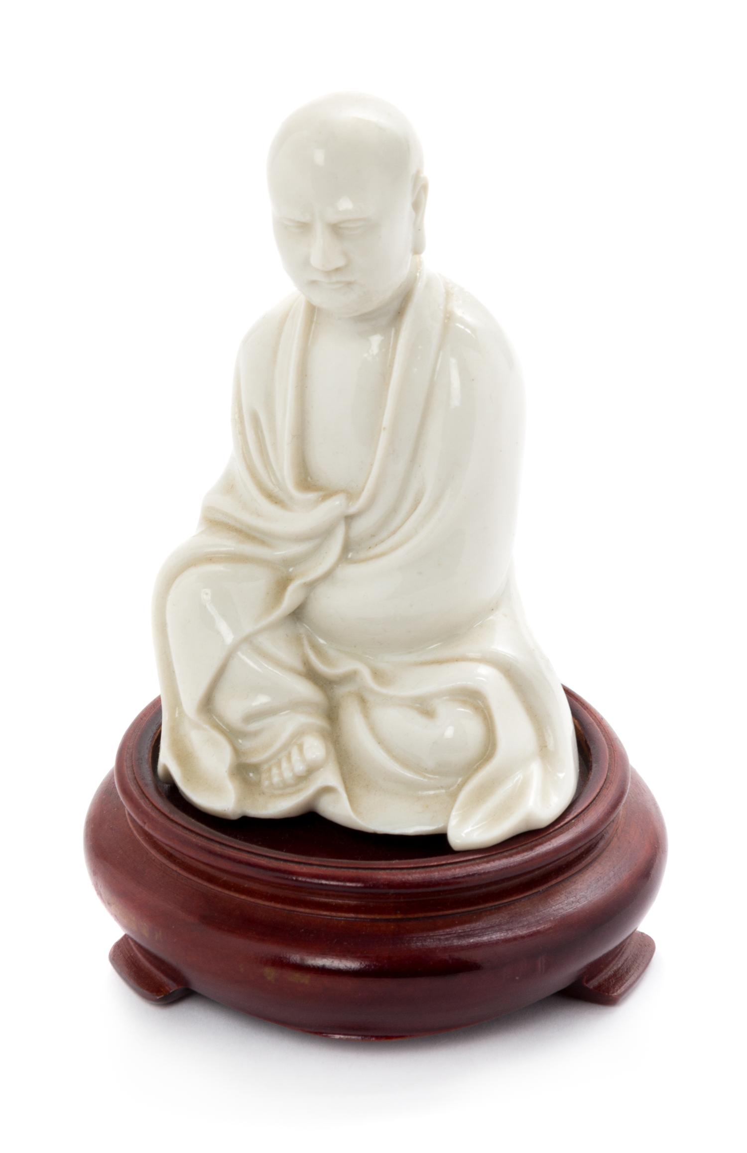 A Chinese Blanc-de-Chine Porcelain Figure of a Luohan Height 4 inches. — QING DYNASTY