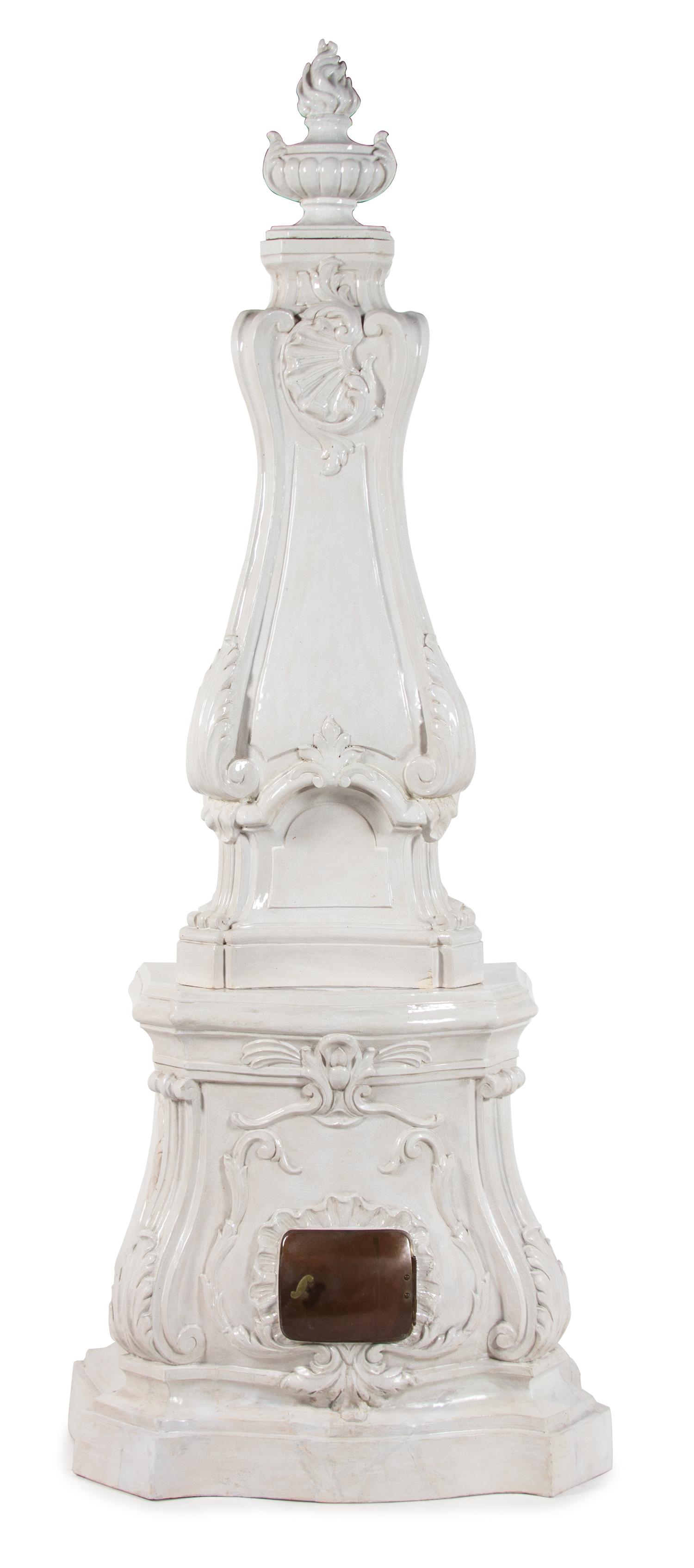 A Continental Rococo Style White Glazed Faience Stove Height 88 x width 35 x depth 20 inches. — 20TH CENTURY