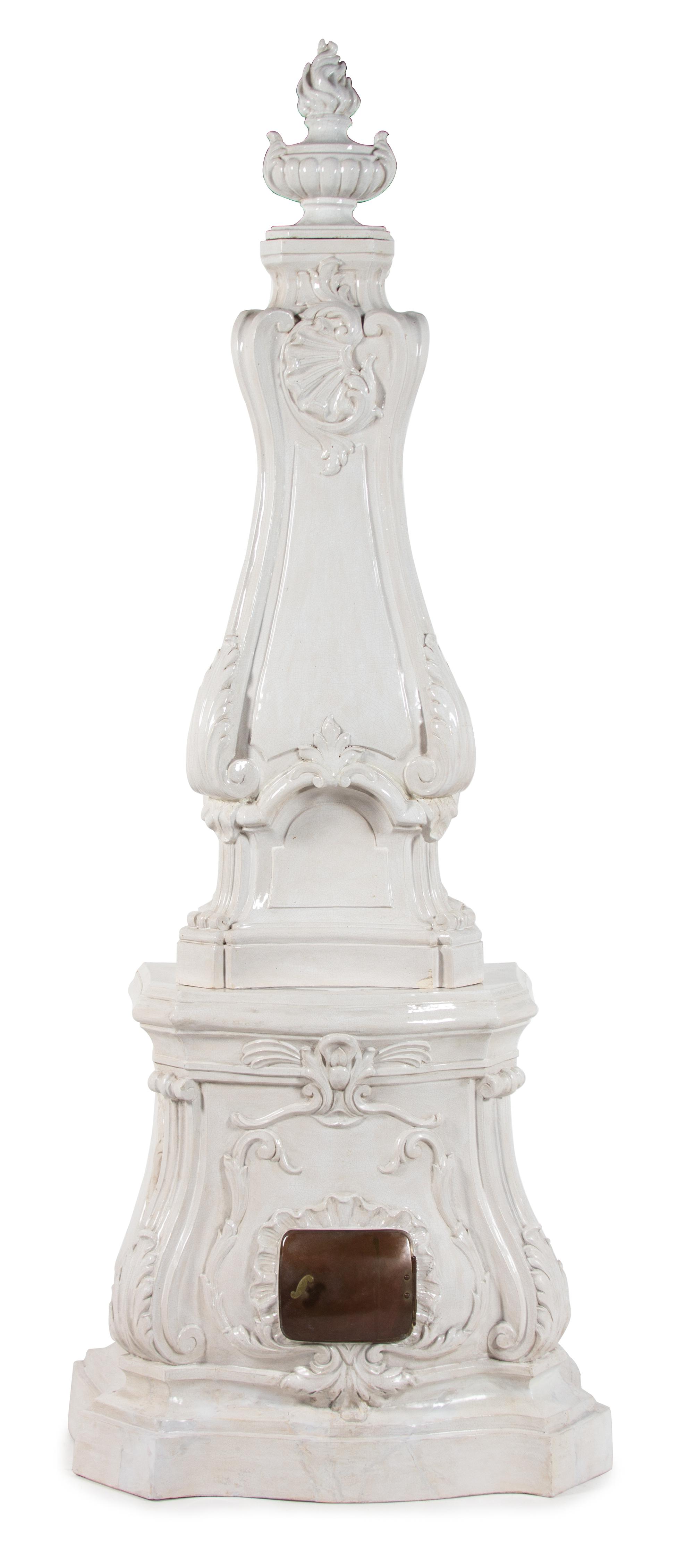 A Continental Rococo Style White Glazed Faience Stove Height 88 x width 35 x depth 20 inches. — 20TH CENTURY
