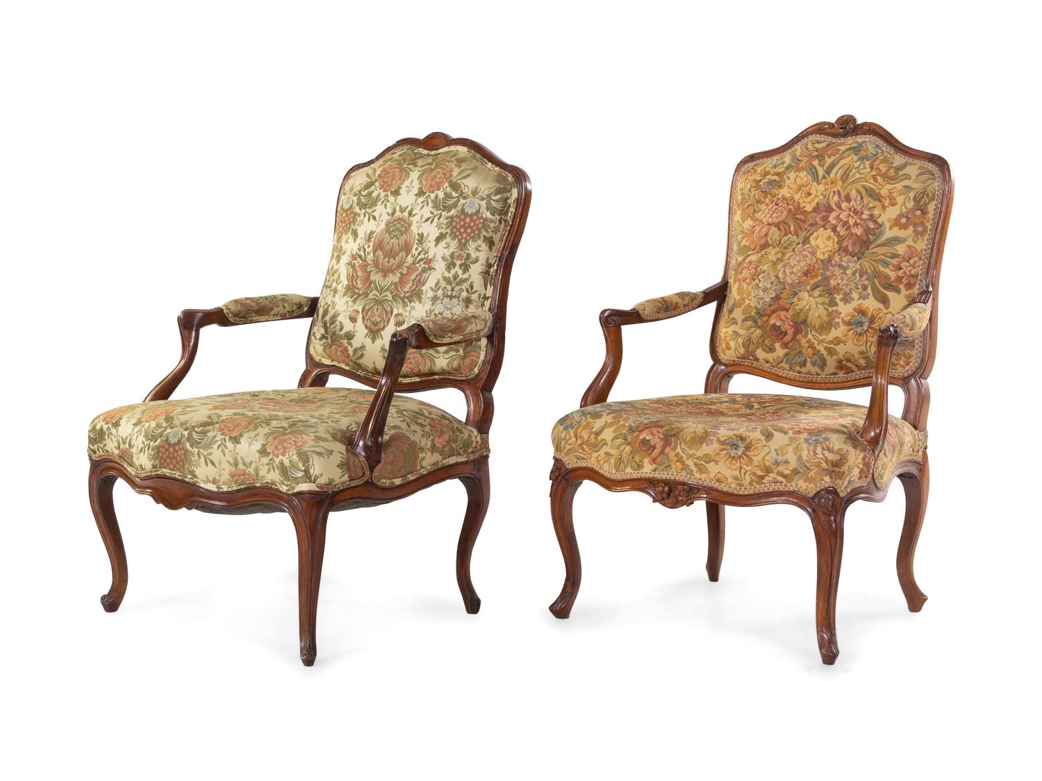 A Pair of Louis XV Style Carved Walnut Fauteuils