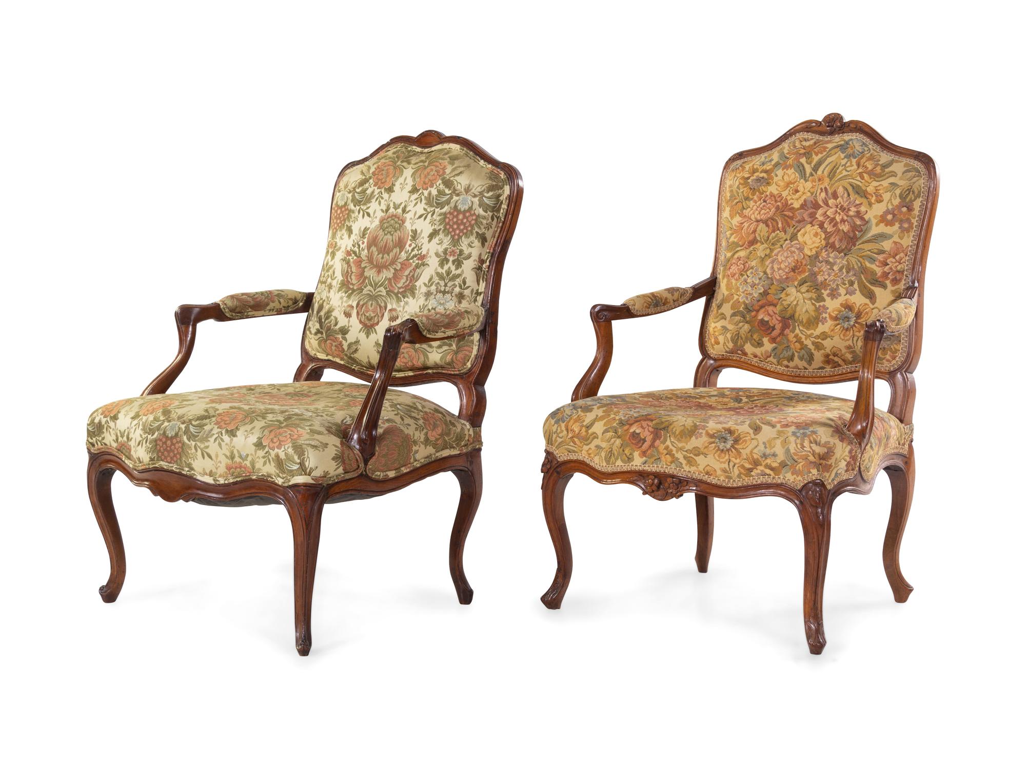 A Pair of Louis XV Style Carved Walnut Fauteuils