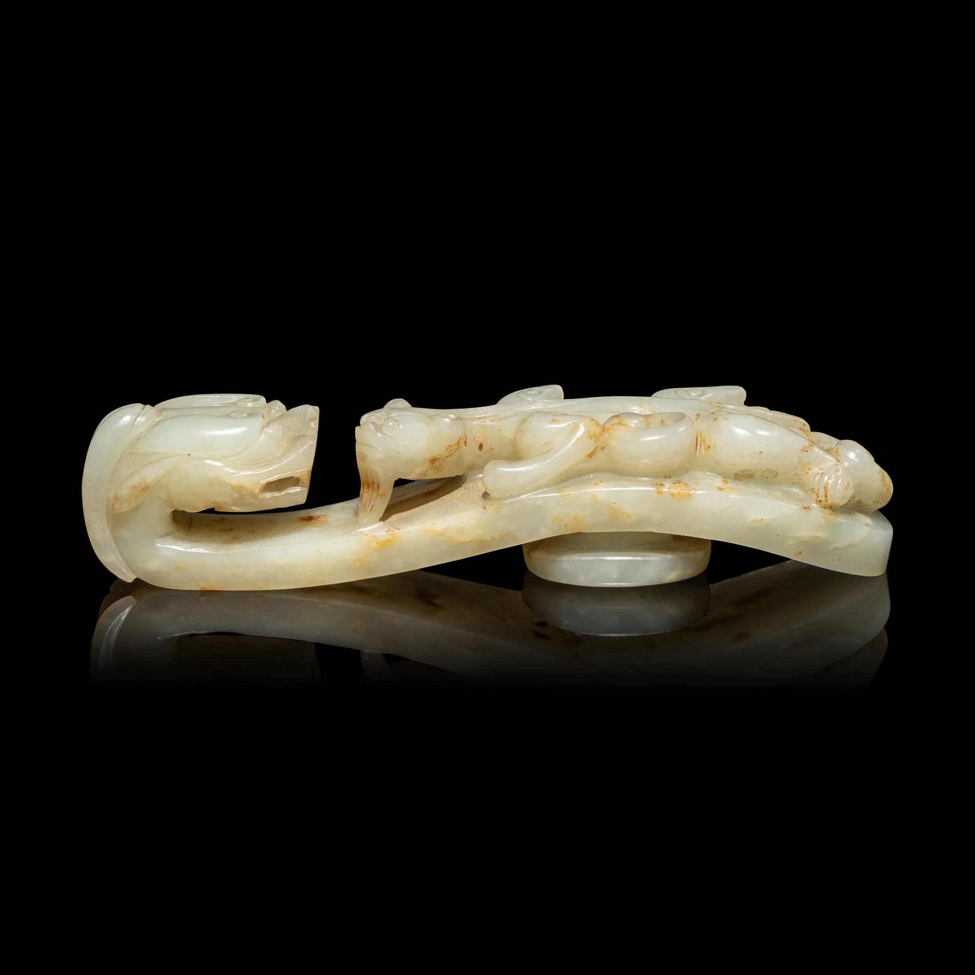 A Chinese Pale Celadon and Russet Jade 'Dragon' Belt Hook, Qing Dynasty 清 青白玉灑金皮蒼龍教子帶鉤