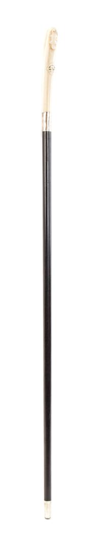 An American Inuit Carved Walrus Ivory Handled Walking Stick, Length of handle 5 3/4 x length overall 34 1/2 inches.
