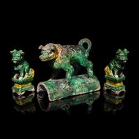 A Chinese Sancai Glazed ' Lion' Roof Tile and a Pair of Figures of Lions, Ming Dynasty 明 素三彩佛獅瓦當及佛獅像一對
