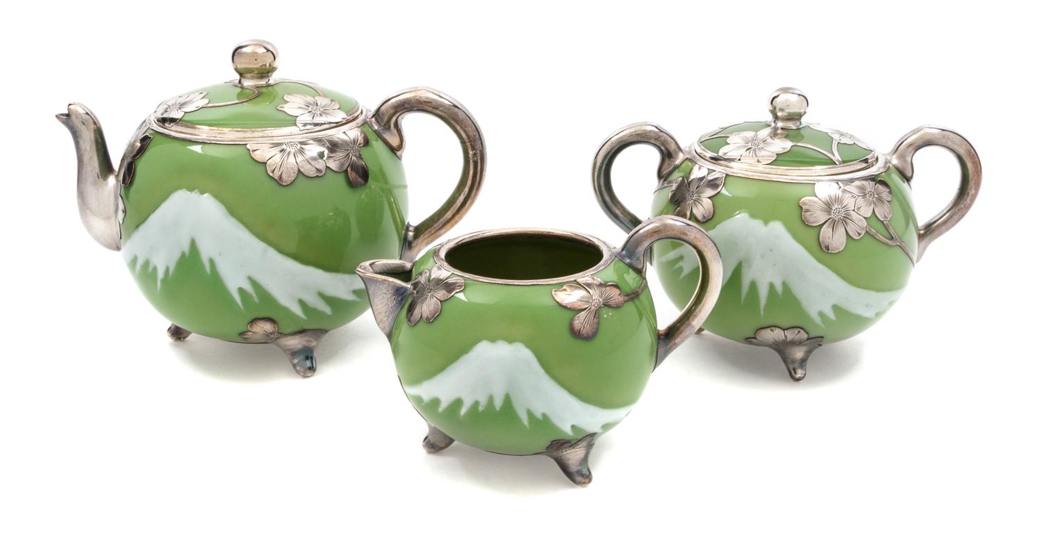A Porcelain Silver Overlay Tea Service, retailed by Shreve & Co. Height of teapot 5 1/2 inches.