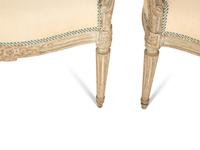 A Set of Four Louis XVI Grey-Painted and Parcel Gilt Fauteuils