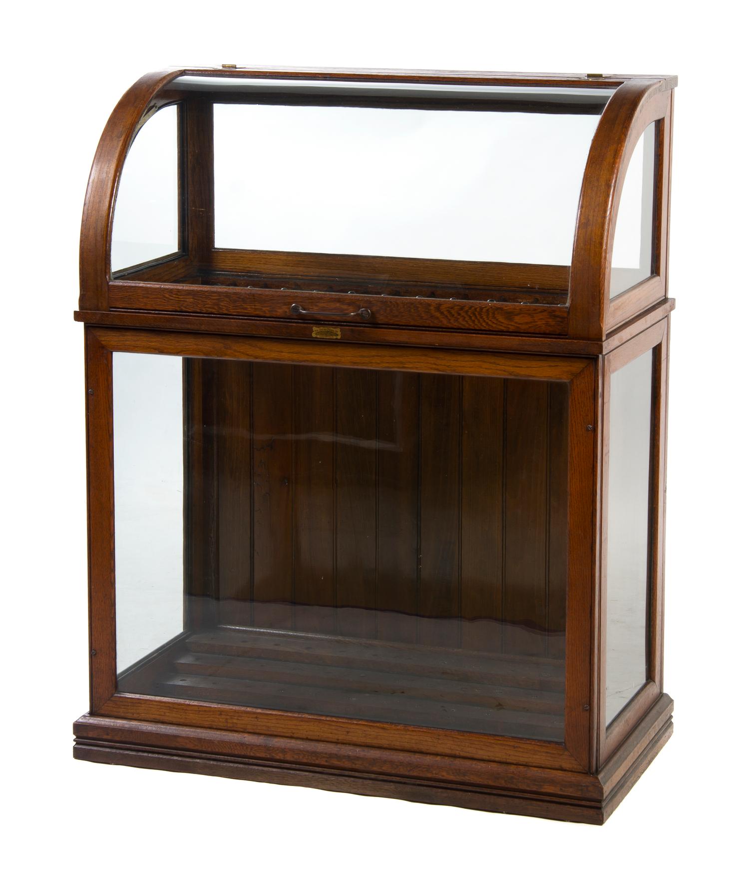 An American Oak Cane Case, The Oscar Onken Co., Height 45 1/2 x width 35 1/2 x depth 18 1/2 inches.