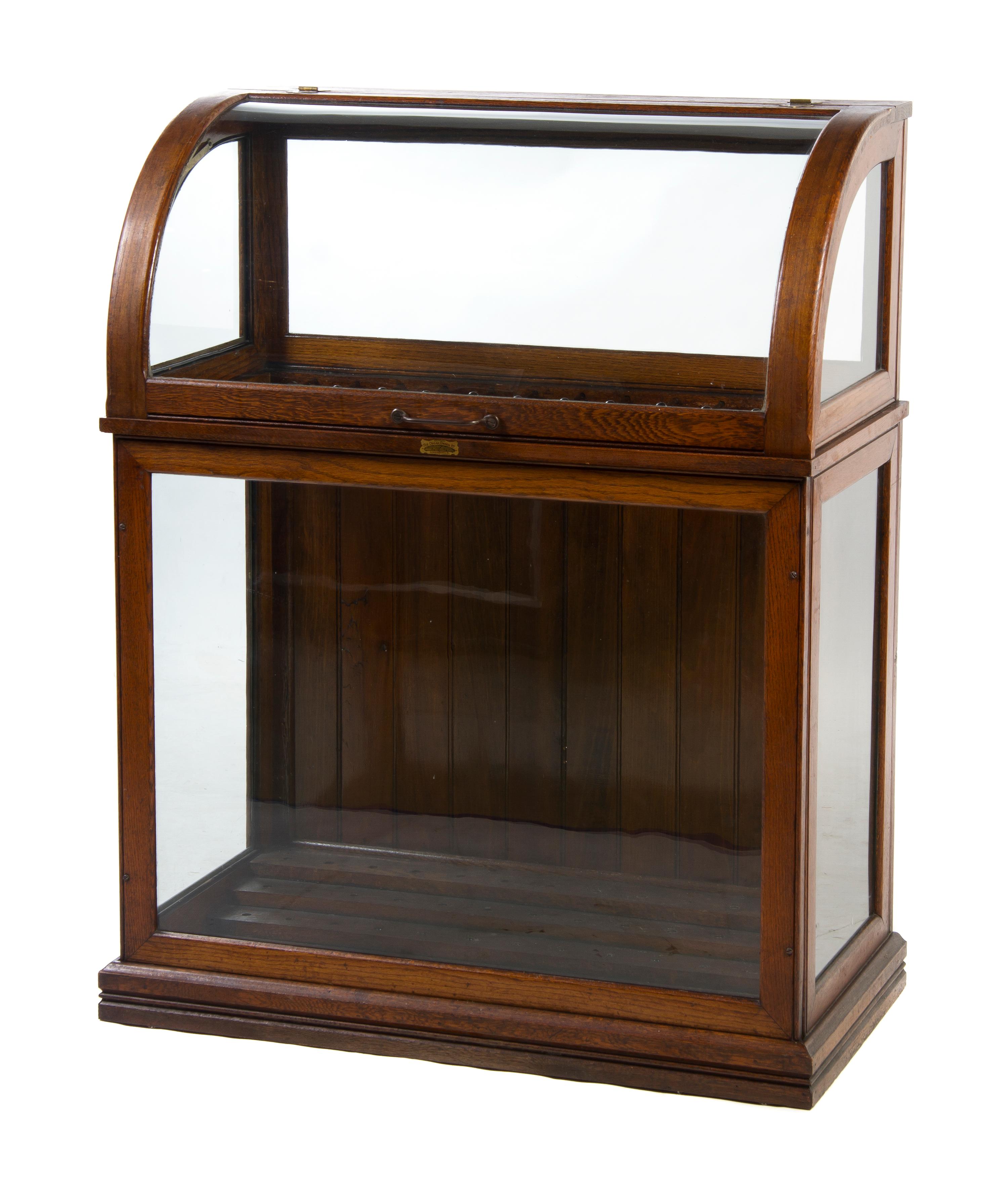 An American Oak Cane Case, The Oscar Onken Co., Height 45 1/2 x width 35 1/2 x depth 18 1/2 inches.